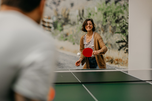 Shot of young businessmen playing table tennis at work. Games between employees during a work break