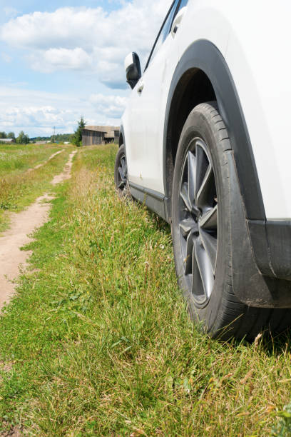 istock white car stands on the side of  road 1429561789
