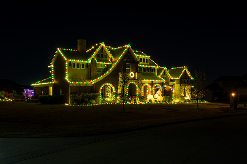 Dallas, Texas, USA - December 18th, 2021: Private residence house decorated and illuminated in dark for Christmas
