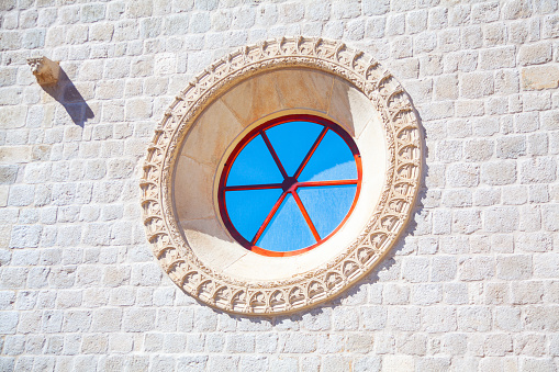 Circular church window . Round cathedral window with stucco