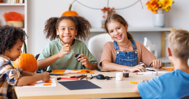 istock Happy multinational group of children making Halloween home decorations together 1429574572