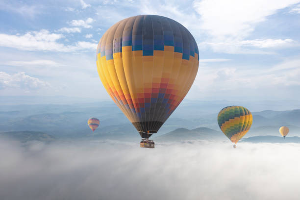 istock Colorful hot air balloon flying above the clouds. 1429574766