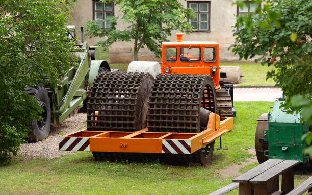 historic road roller in white back with shadow