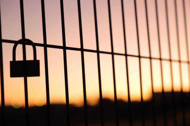 istock padlock placed on fence on sunset background 1429574859