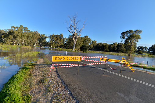 Flood waters over the road.  Road has been blocked.