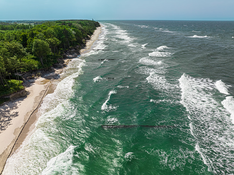 Big waves on Baltic Sea in summer. Tourism at Baltic sea. Aerial view of nature in Poland.