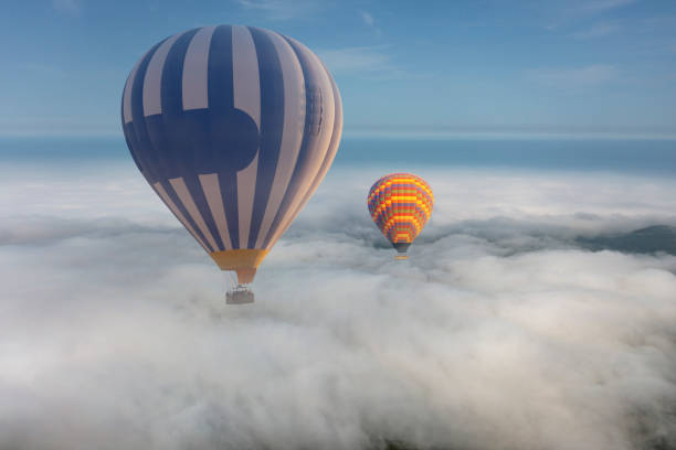 istock Colorful hot air balloon flying above the clouds. 1429575448