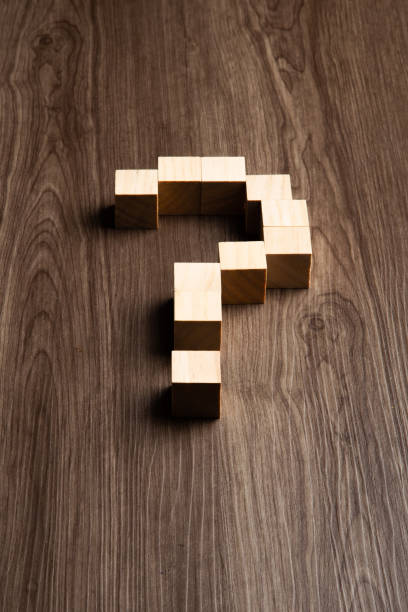 istock Forming bigger question mark. question mark on wooden table background 1429576939