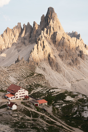 Stunning view of a mountain hut during a beautiful sunset with Mt Paterno in the background. The Three Peaks of Lavaredo are the undisputed symbol of the Dolomites, Italy.