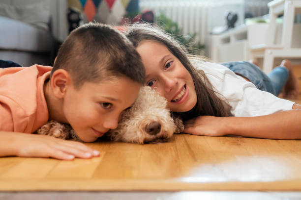 istock Happy kids with dog at home 1429594144