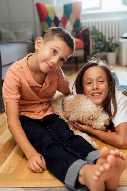istock Happy kids with dog at home 1429594327