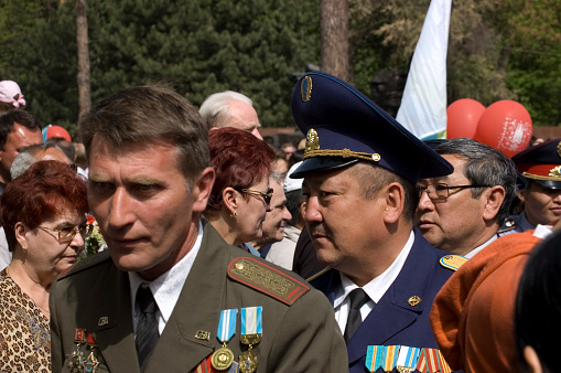 Victory Day is a celebration day that commemorates the victory of the Soviet Union over Nazi Germany in the Great Patriotic War. (Second World War). In Kazakhstan on the 9th of May the people remembering their Heros in the Panfilov Park. The image shows several members of the army and guests during the celebration in Almaty,