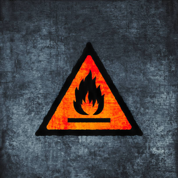 istock Flammable sign on scratched background. Fire hazard symbol, grunge textured. Conflagration risk icon (triangle), red on gray 1429596651