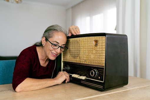 Senior woman listening radio