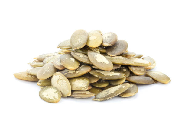 istock Pumpkin seeds on white background. Green pepita seeds. 1429602496