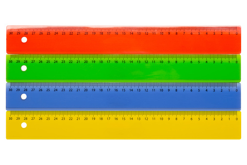 Four colored rulers, with a metric scale for measurements from right to left from zero to 30 centimeters, on a white background, isolate