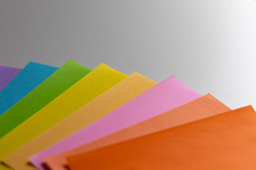 Colorful paper overlapped on white table