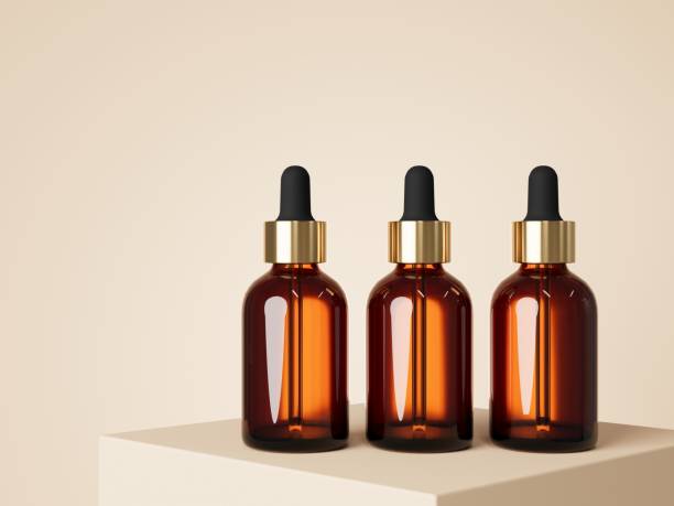 istock Three cosmetic serum dropper brown glass bottle on podium with beige background 3D render, care product packaging and branding visualization 1429609702