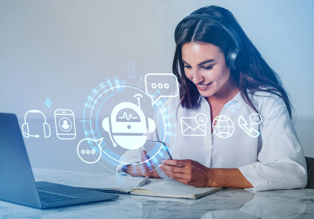 istock Businesswoman with smartphone, computer and digital bot hologram 1429614051