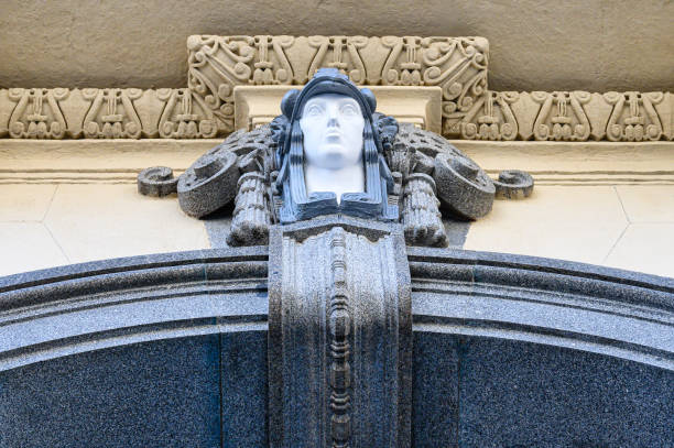 Madrid, Spain - September 30, 2022: Close-up of architectural detail on a building. The detail comprises a human face enclosed by complex stonework.
