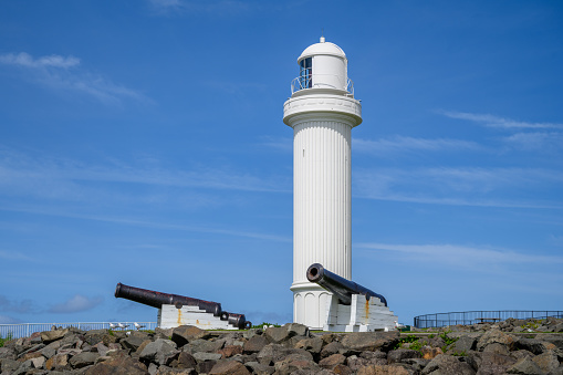 white Lighthouse with two cannons