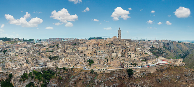 Ancient Unesco heritage old town of Matera (Sassi di Matera), Basilicata, southern Italy. Prehistoric cave dwellings, European Capital of Culture 2019. People are unrecognizable.