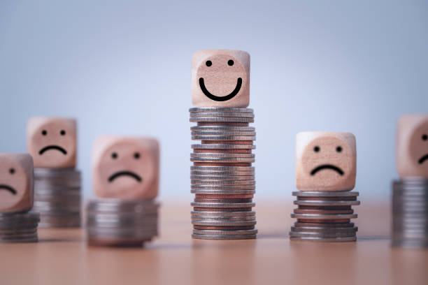 Coin stacking on smiley face and sad face for good financial planing can make happiness in life, Money saving and investment concept. Coin stacking on smiley face and sad face for good financial planing can make happiness in life, Money saving and investment concept. uneven stock pictures, royalty-free photos & images