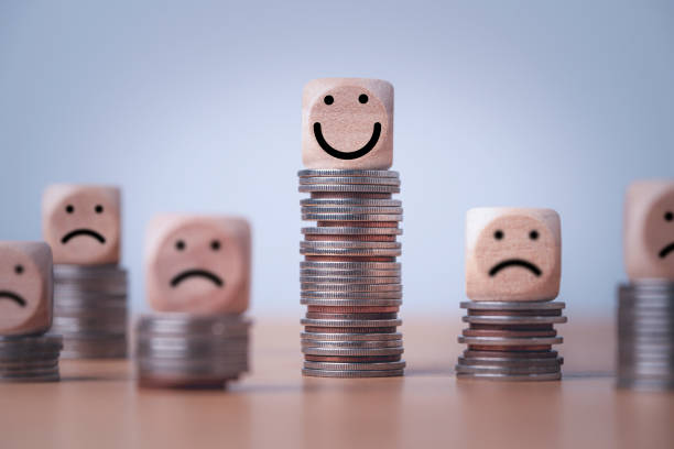 coin stacking on smiley face and sad face for good financial planing can make happiness in life, money saving and investment concept. - uneven imagens e fotografias de stock