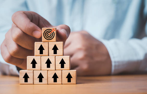 istock Hand putting virtual target board and arrow which print screen on wooden cube. Business achievement goal and objective target concept. 1429629183