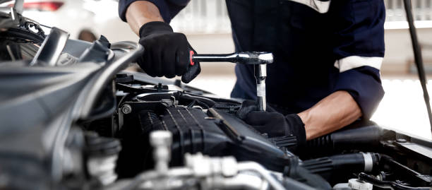 istock Car care maintenance and servicing, Close-up hand technician auto mechanic using the wrench to repairing change spare part car engine problem and insurance service support. 1429636089