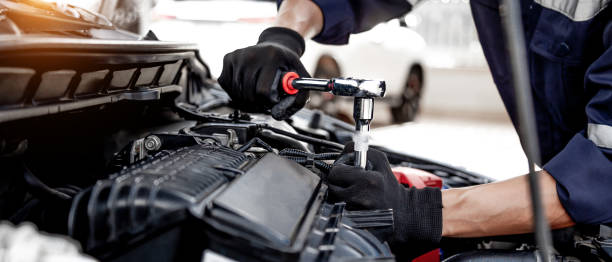 istock Car care maintenance and servicing, Close-up hand technician auto mechanic using the wrench to repairing change spare part car engine problem and insurance service support. 1429636095