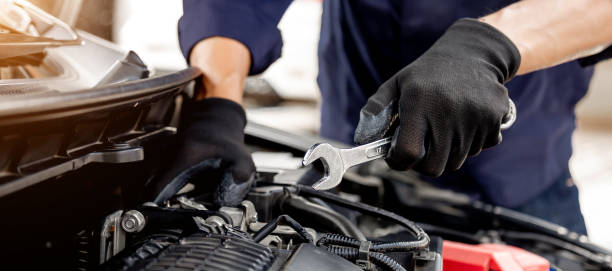 istock Car care maintenance and servicing, Close-up hand technician auto mechanic using the wrench to repairing change spare part car engine problem and insurance service support. 1429636097