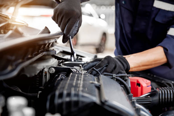 istock Car care maintenance and servicing, Close-up hand technician auto mechanic using the wrench to repairing change spare part car engine problem and insurance service support. 1429636100