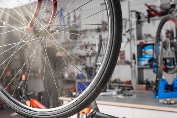 istock Experienced mechanic repairs bicycles and its components in professional garage 1429645327