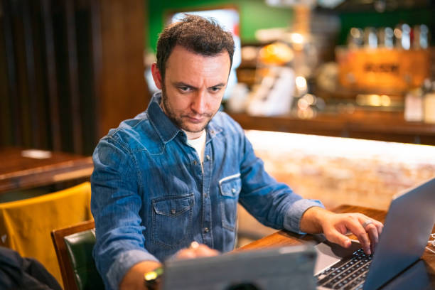 istock Freelance working man using laptop and digital tablet in a cafe 1429645945