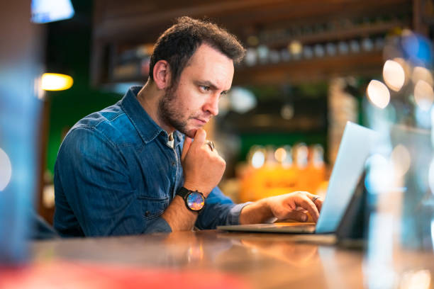 istock Freelance working man using laptop and digital tablet in a cafe 1429646033