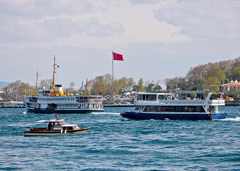 Istanbul, Turkey - April 4, 2019: Tourists taking a boat over the Bosporus to Asian part of the Istanbul in a sunny day with bosphorus scene.