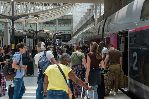 Roissy-en-France, France - 27 June 2022: Passengers boarding TGV high-speed train at Paris-CDG airport railroad station
