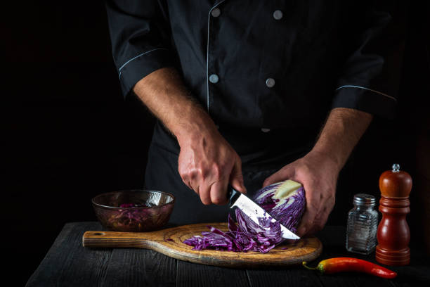 istock A professional chef cuts red cabbage with a knife. Cooking vegetable salad in the restaurant kitchen. Vegetable diet idea. 1429649397