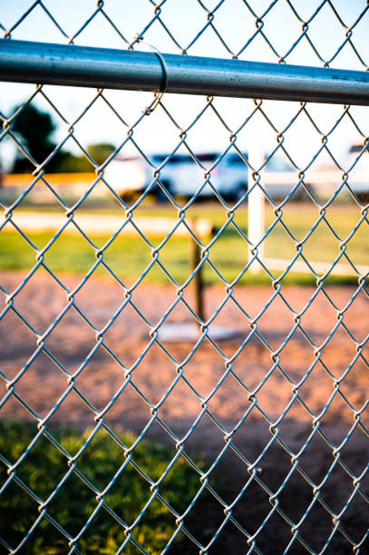 istock Focus on chain link fence with t-ball background 1429655359