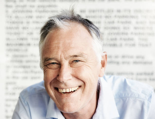 Handsome, happy middle-aged man against a background of blurred text