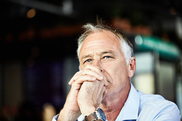 istock Handsome middle-aged man looking serious and thoughtful, resting his chin on his hands 1429656861