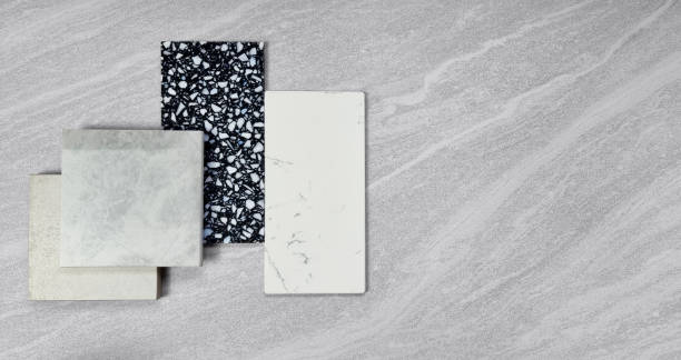 istock top view of interior material samples contains gloss and matt grey tiles, black and white terrazzo artificial stone, white marble quartz placed on grey travertine background. interior material board. 1429665657