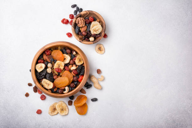 istock Wooden bowls with dried fruit, berries and nuts 1429666200
