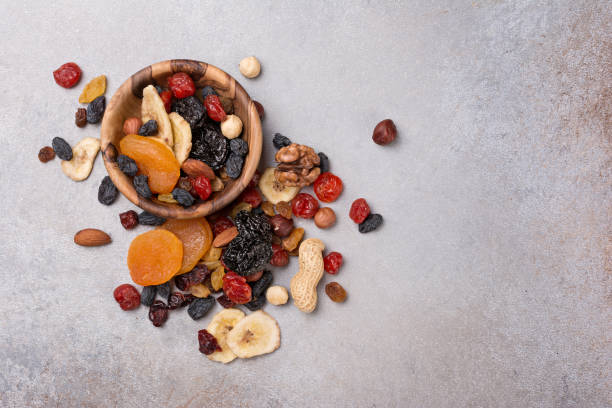 istock Wooden bowls with dried fruit, berries and nuts 1429666421