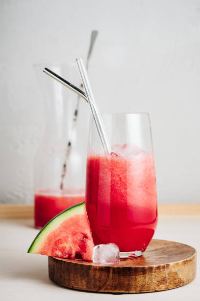 Refreshing watermelon Agua fresca drink. Refreshing watermelon Agua fresca drink in a glass with a straw. watermelon juice stock pictures, royalty-free photos & images