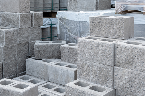 Stack of cement concrete Building cinder blocks brick on pallete in hardware store