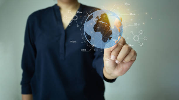 istock Woman pointing at globe created with holographic graphics, 1429674810