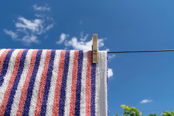 istock Clothes peg on a towel and washing line against a blue sky 1429675600