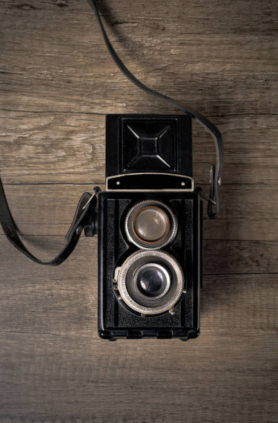 istock Vintage camera on wooden background 1429676023